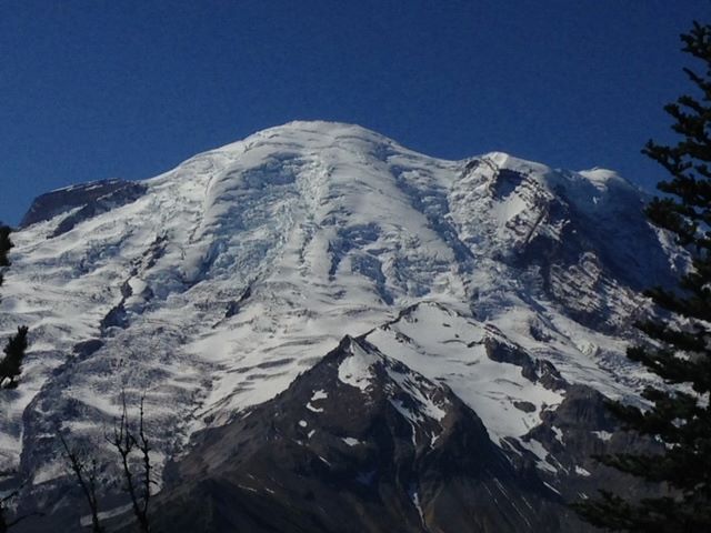 Snow-covered Mt. Rainier backed by a blue sky