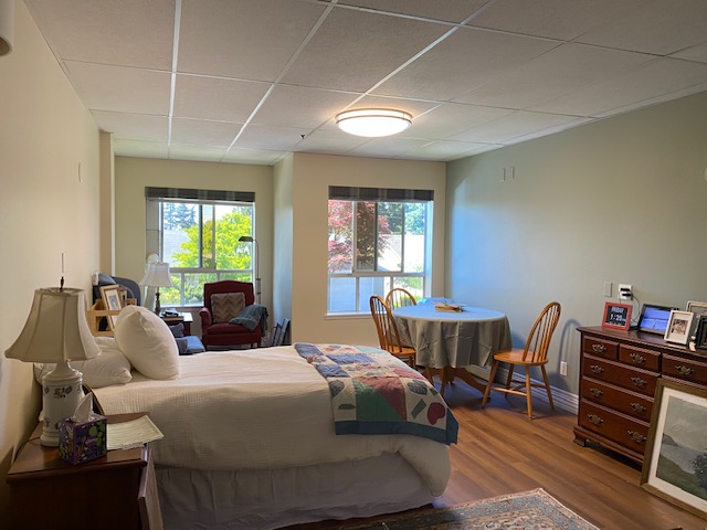 A pleasant room with bed, chairs, dresser, etc. in a Memory Care facility