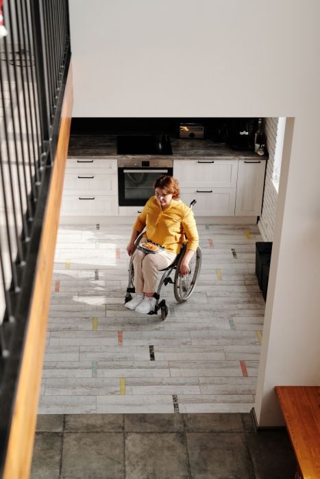 Woman wheeling herself in wheelchair