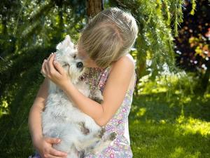Girl hugging dog