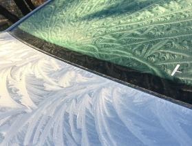 Ice artistry in a windshield of a Chevy Cruse