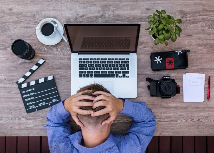 Man at the computer trying to write a screenplay