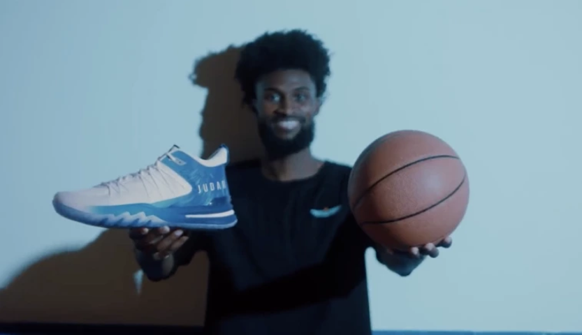 Christian NBA player Jonathan Isaac poses with shoes from his UNITUS JUDAH 1 sneaker line in a promotional video