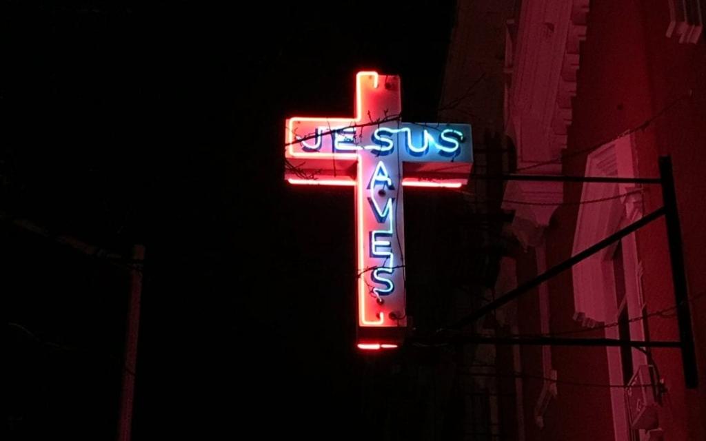 A neon Jesus Saves sign