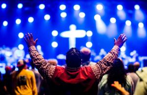 Man with outstretched arms at church