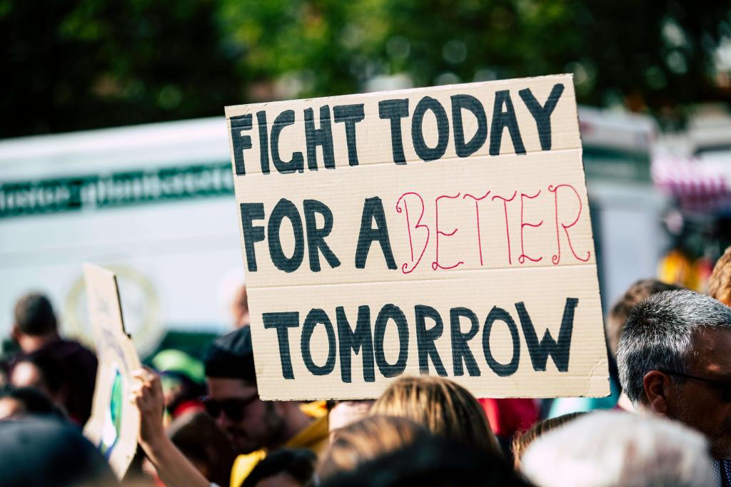 A political protest featuring a sign "Fight today for a better tomorrow"