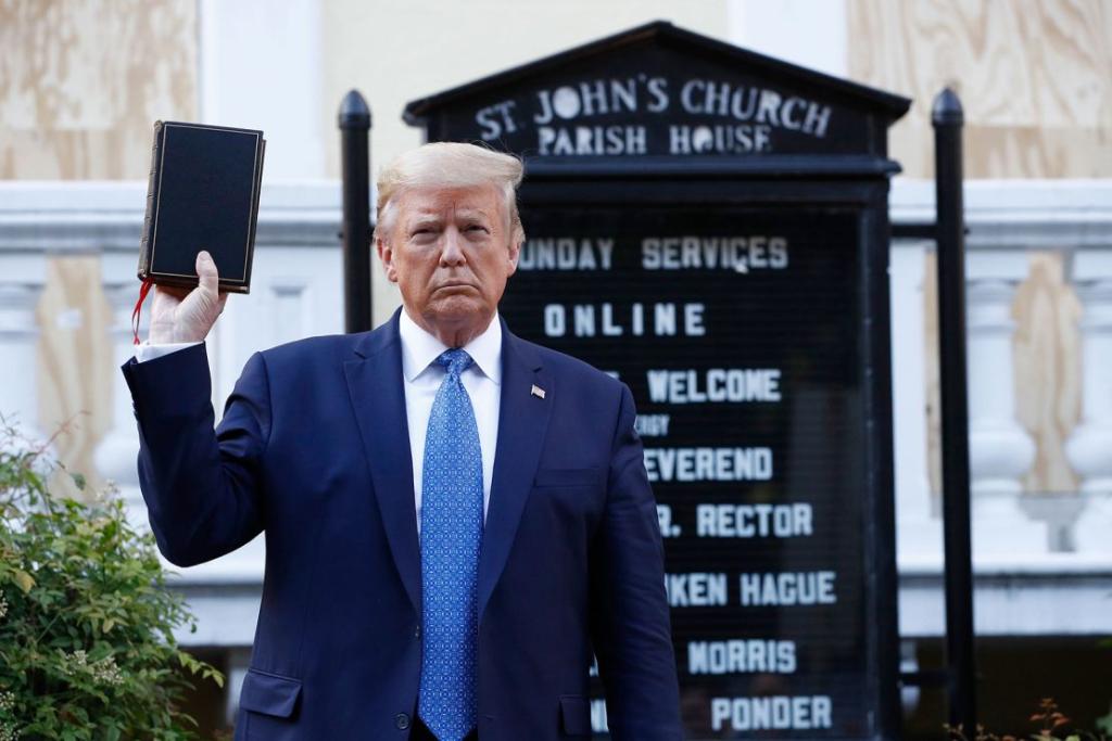 President Donald Trump standing outside a church holding an unopened Bible