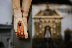 A close-up of a statue of Jesus' pierced feet during his crucifixion.