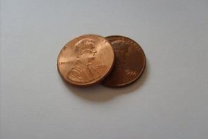 Two pennies, one resting on another to symbolize "My 2 cents"