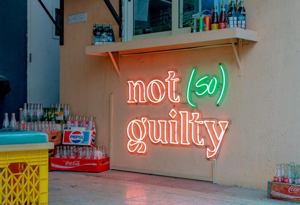 A neon sign reading "not so guilty" with the word so in parentheses
