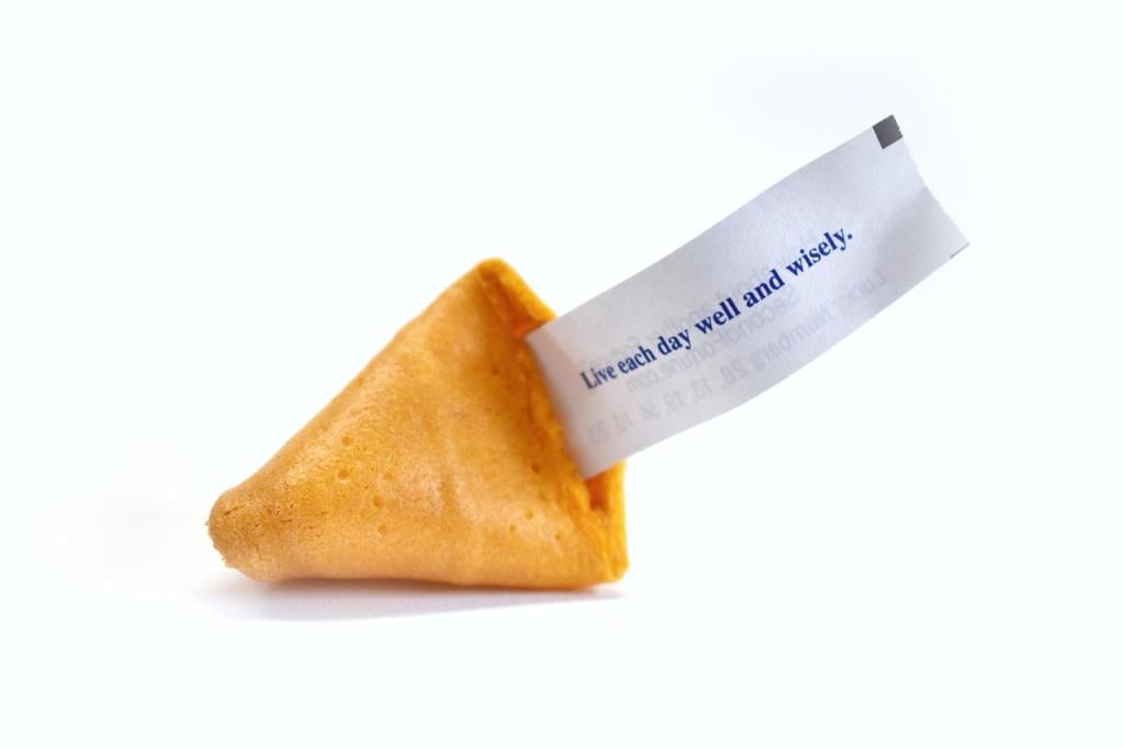 A fortune cookie resting on a table providing its own version of what a prophet does.