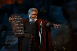 A man as Moses holding up the 10 commandments in a Hollywood movie around 1958