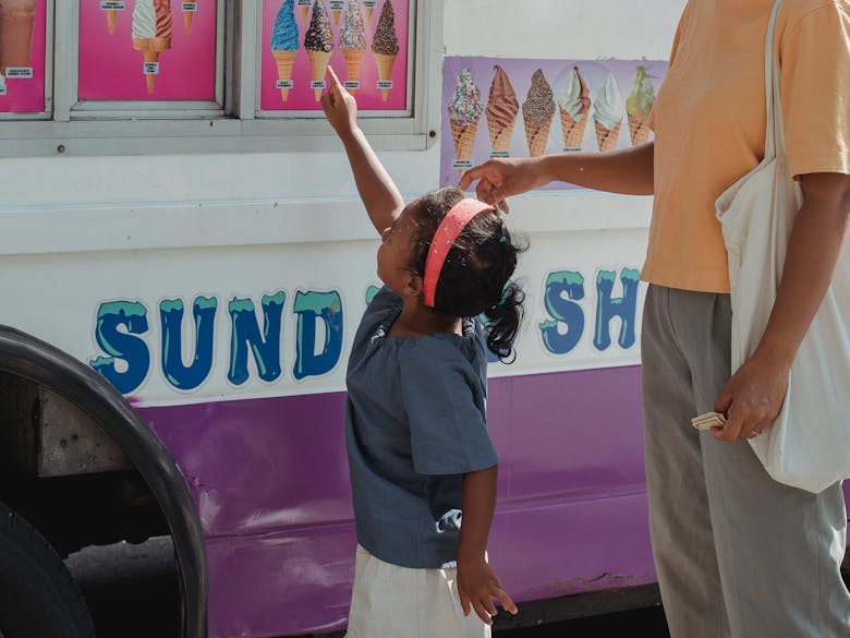 Little girl choosing a ice cream cone. 