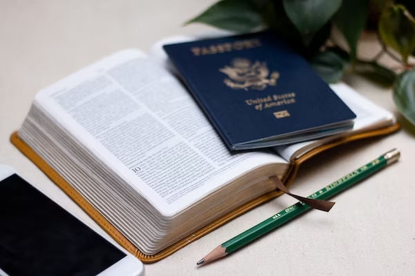 Open Bible with US passport sitting on top of it