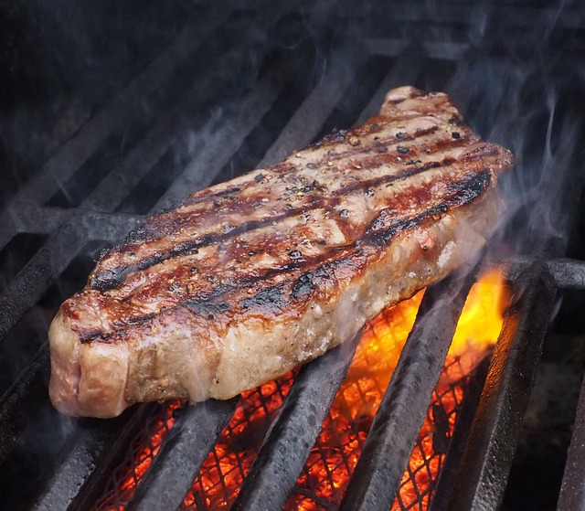 Steak being grilled over a fire