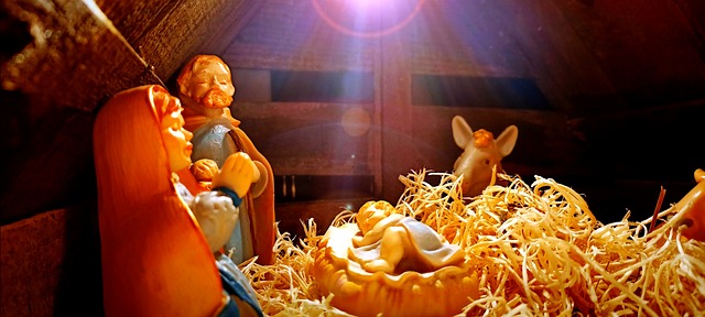 Nativity scene in stable with Mary, Joseph and Baby Jesus who's in the manger.