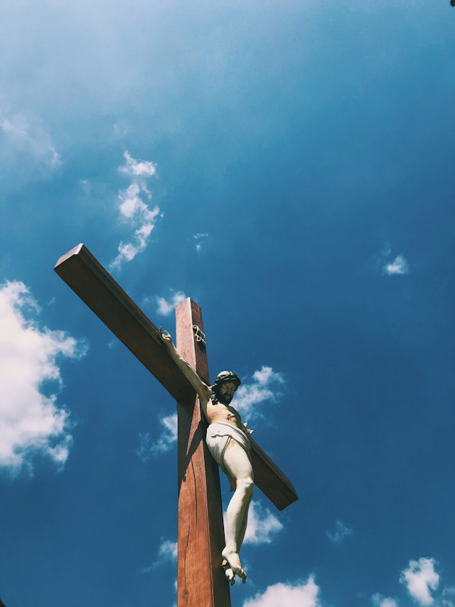 Jesus hanging on cross with the background of a blue sky