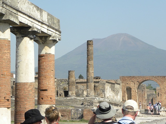 Mount Vesuvius rises in the background of ancient ruins.