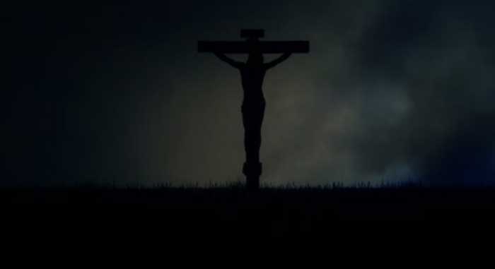 Vague view of man on cross in the darkness