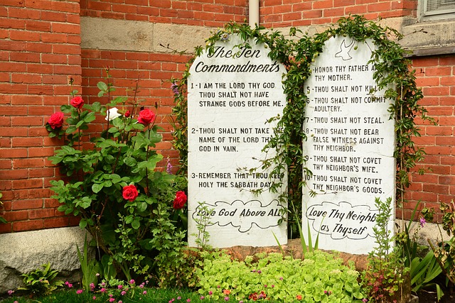 Garden setting wo large white stone tablets on which the Ten Commandments are written