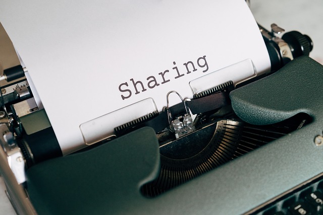 Typewriter with paper inserted on which is typed the word "Sharing" 