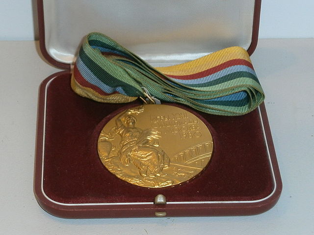 Olympic gold medal displayed in an open box 