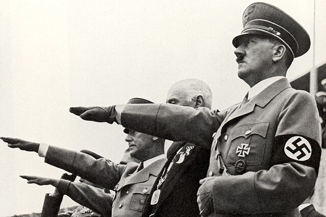 Side view of Adolf Hitler saluting athletes at the 1936 Summer Olympics opening ceremony