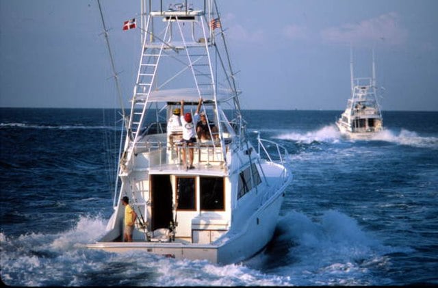 View from behind of charter boats headed out to see for fishing
