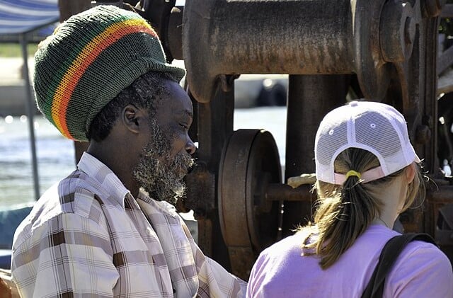 Side view of older black male from the shoulders up wearing a rastacap