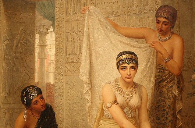 Color image of Queen Esther seated in her harme with two attendants, one on either side of her. One attendant is standing and one is seated and looking at her.