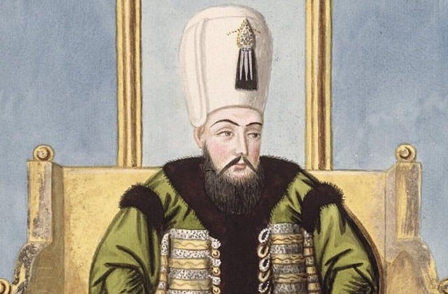 Painting of Sultan Ahmed I who appears seated on a gold bench with a tall ligth-colored head covering, a beard and mustache, and a green and black outfit