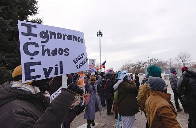 Protestors on the street carrying signs against ICE action in Minneapolis 