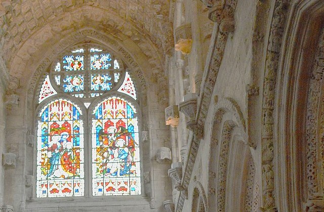 Ornate stonework and stained glass windows in the interior of Rosslyn Chapel