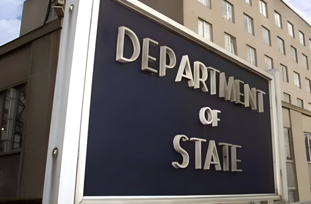 View of sign identifying building in background as the Department of State