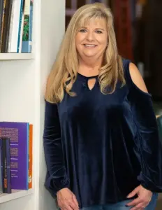 picture of woman leaning on bookcase