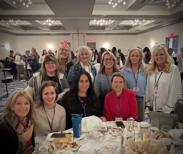 Smiling women gathered for the Bloom Again Conference in Virginia Beach.