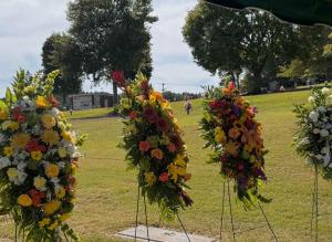 Floral arrangements at a graveside memorial.