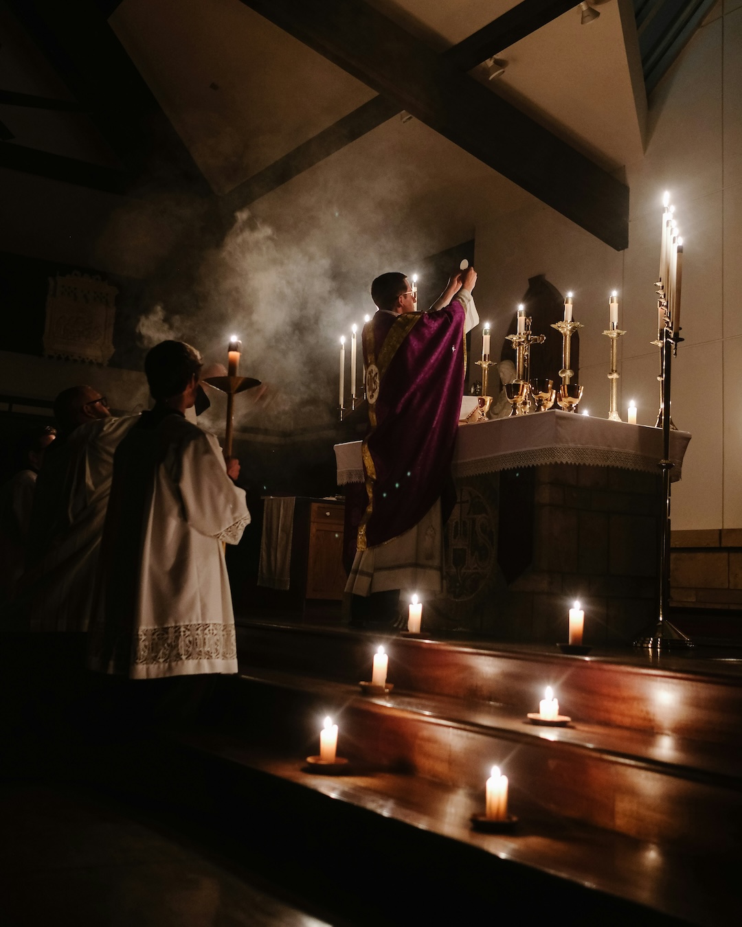 Priest Celebrates Mass by Candlelight