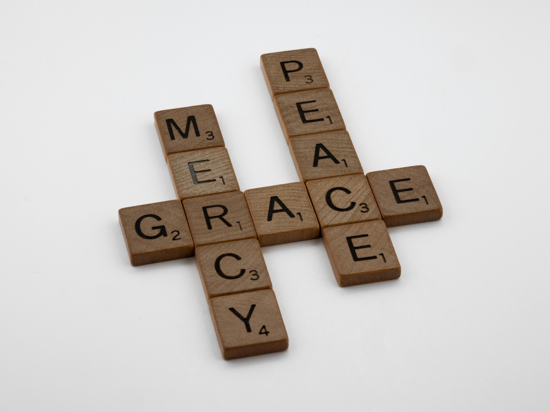 Scrabble tiles spelling mercy, grace, and peace