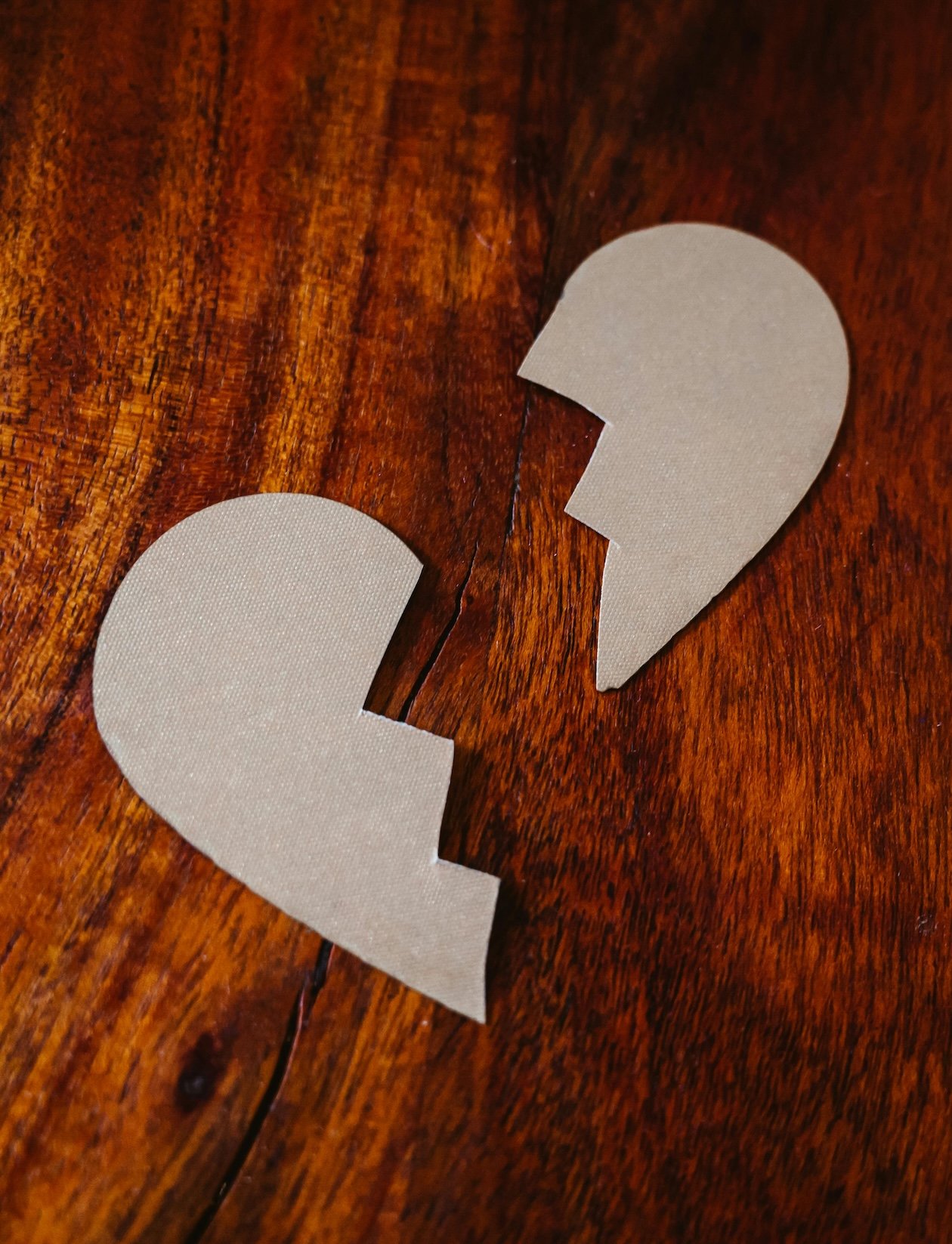 Broken paper heart conveys the pain of betrayal