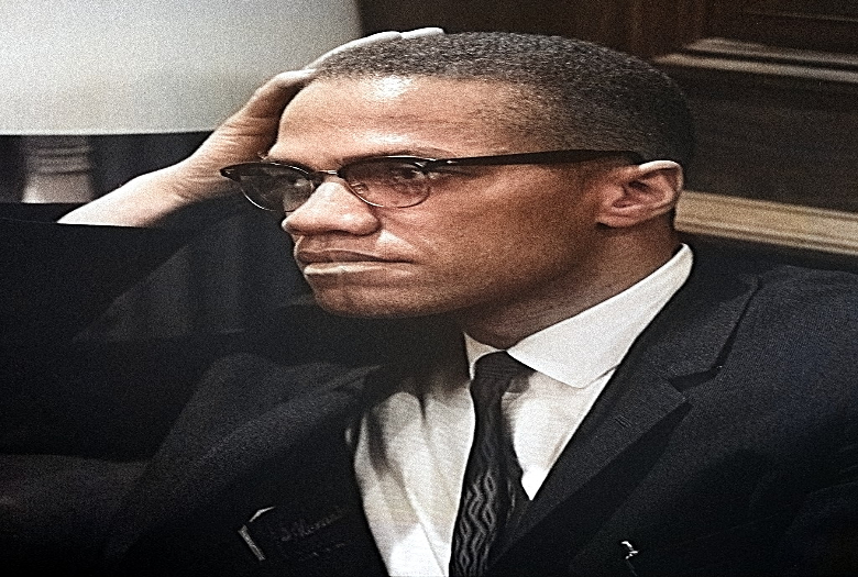 Malcolm X waiting for a press conference to begin on March 26, 1964.
