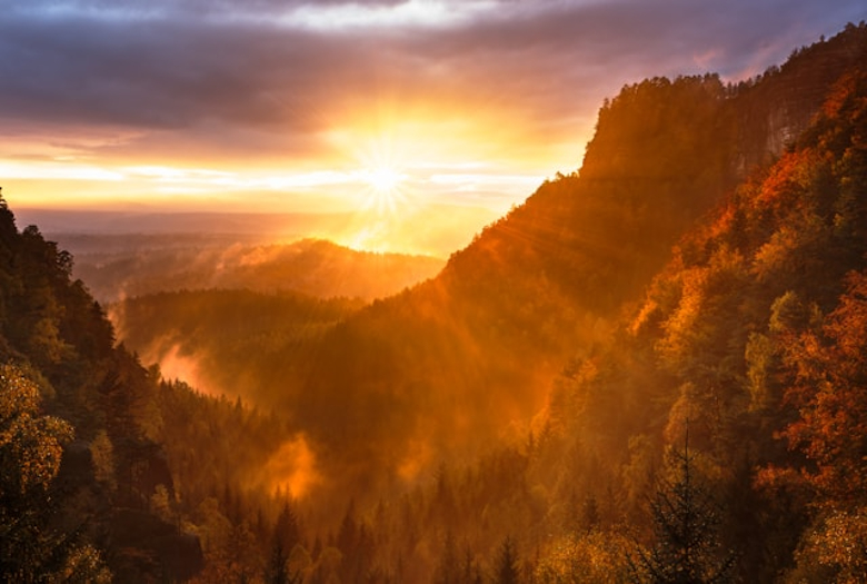 The sunrise captures the hope one has knowing God is able to do anything. The mountain and trees reflect the serenity within God's creation.