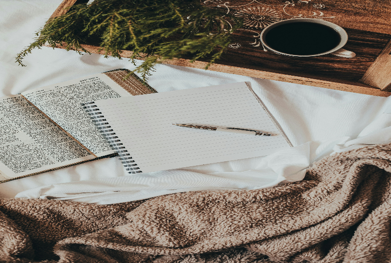 Cozy scene with the Word of God, a journal and a cup of coffee.