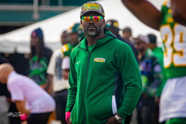 MBShuler72, CC BY-SA 4.0 <https://creativecommons.org/licenses/by-sa/4.0>, via Wikimedia Commons Michael Vick Norfolk State Head Coach standing on the sidelines.