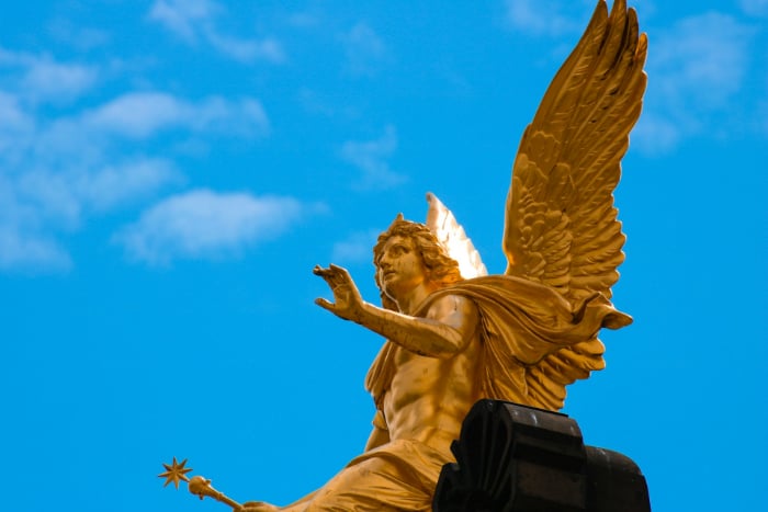Angelic beings are represented in this picture in the form of a golden statue.