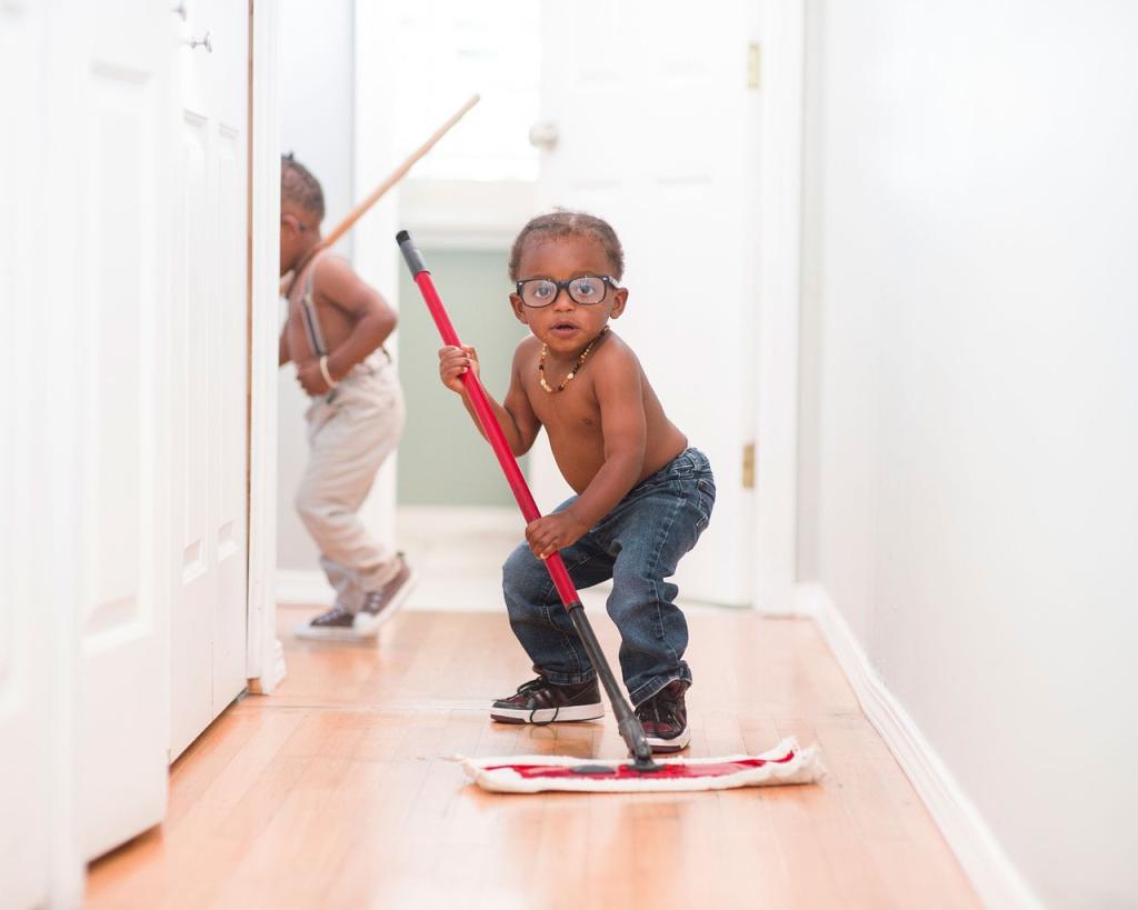 Child with glasses mopping floor in a funny squatting pose.