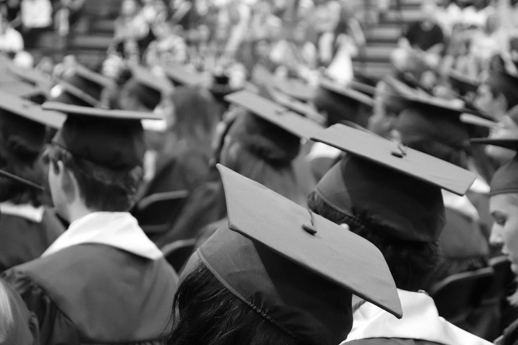 crowd of graduates in black and white