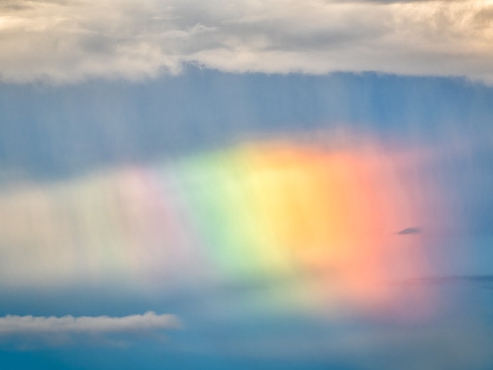 Rainbow coming out of the clouds.