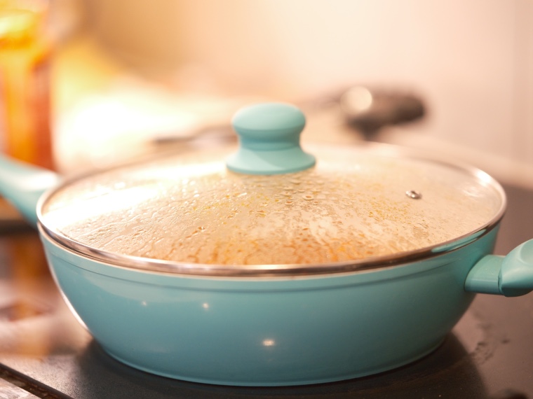 Teal colored skillet pan on stove