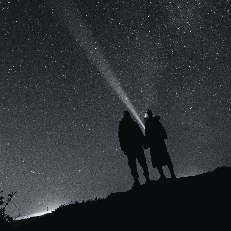 Two people looking at the night sky